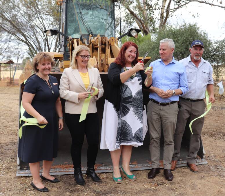 Deputy Prime Minister and Federal Infrastructure, Transport and Regional Development Minister Michael McCormack (second right) looks a little wary as Durack MP Melissa Price next to him waves sharp scissors 
