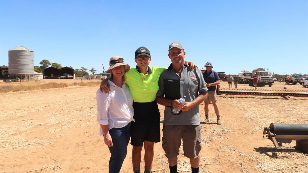Vendors Jane and Brett Lang (right), Bresland Farming, with son Callum, 13, who was allowed the day off from boarding school in Perth to attend the clearing sale. The family will continue to live on the property but has leased the paddocks out.