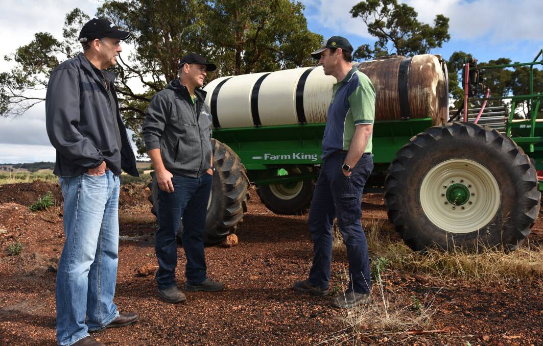 Damon Fleay (left), SACOA and grower Mark Fowler (right), discuss the latest in liquid delivery solutions with Jason Young (centre), Furrow Management Systems Australia.