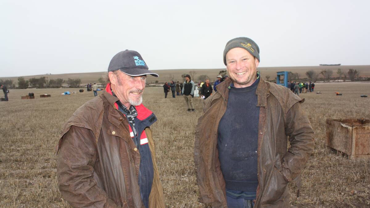 Rain always brings smiles and Ian Garard (left), Newdegate and Nathan Gilmour, Lake Biddy, didn't mind stopping for Farm Weekly on their way to checking out the bidding in the sundries lines.