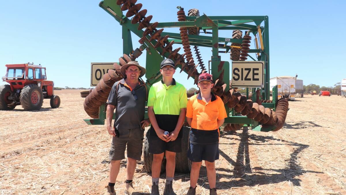  Mark Sutton (left), Mollerin, with Callum Lang, 13, son of the vendors, and his own son Mac, 12. The boys became best mates at Kalannie Primary School and now attend boarding schools in Perth but had the day off to attend the sale. They are standing behind a 2012 18.2 metre wide Kelly diamond harrows that was heading for Salmon Gums after being bought for $135,000.