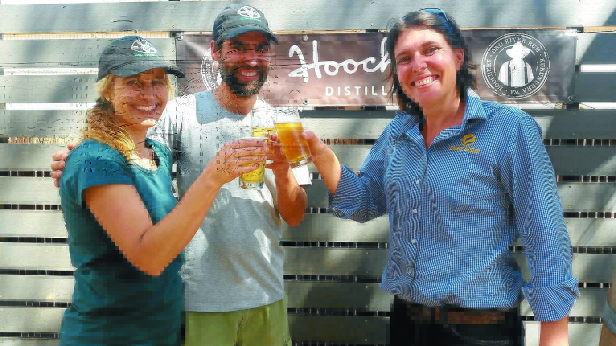 Lucky Bay Brewing owners Robyn Cail and Nigel Metz sample the Beach to Boab corn beer with Kalyn Fletcher of Hoochery Distillery.