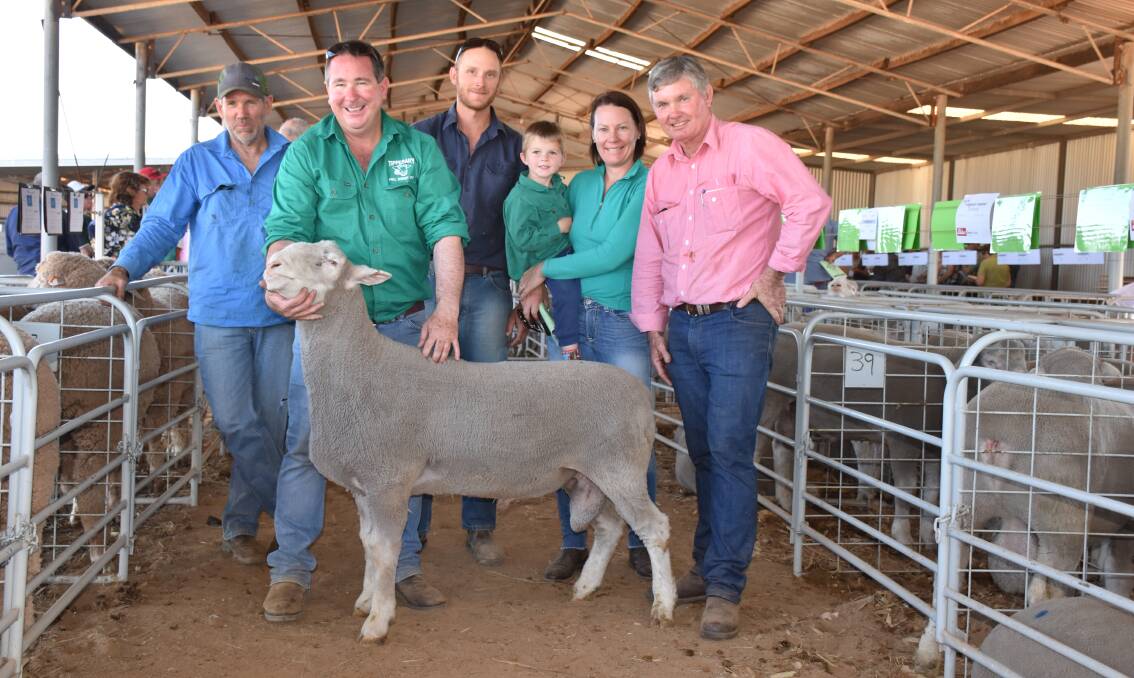 Tipperary studmaster Randal Levett holds one of the $1800 equal top price Poll Dorset rams at last week's Chapman Valley ram sale. He is with buyers Nigel Moffatt (left), Moonyoonooka, and Mt Ferguson Grazing Co farm manager Brad Skraha, Boyup Brook, who both paid the top money. With him is wife Kristy, son Callum and Neil Johnstone, Elders Geraldton.