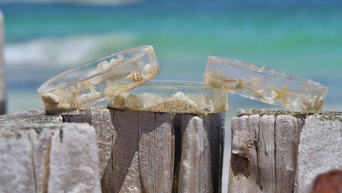 Some of the acrylic bangles made by Kiera using legally sourced sea shells, pieces of seaweed and Jurien Bay beach sand. These bangles also contain Sea Spray Art's signature photoluminescence.