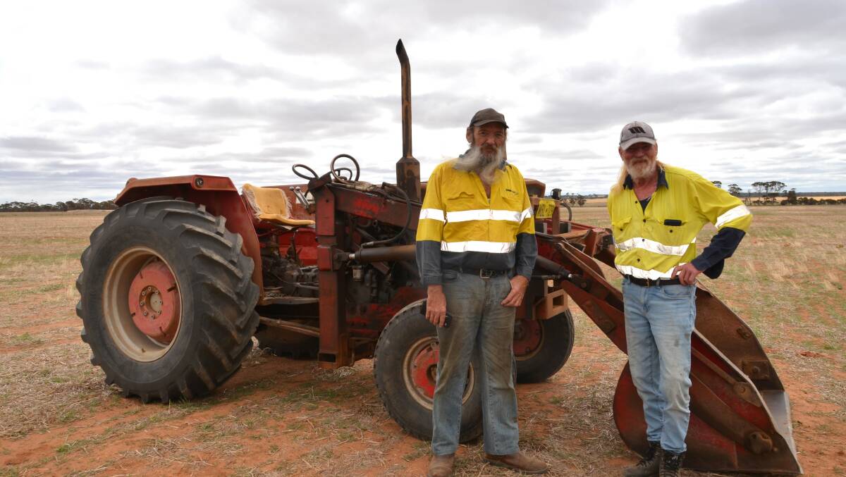 Jeff McIntosh (left) and Jim Tilbrook, both from Koorda, with the smallest tractor on offer at the sale, an elderly Massey Ferguson 168 with front-end loader and three-point linkage, complete and in good condition for its age. Strong initial interest petered out at $7000 and it was passed in.
