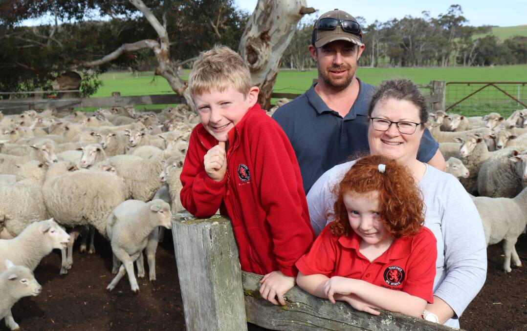 Mark and Kylie Wallace, Woogenellup, with their children Adam and Sophie and some of the Dohne cross ewes they breed on their property.