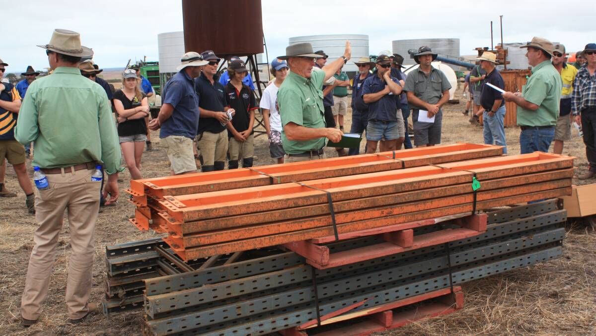 It didn’t take long for keen bidding to start with lot seven in the sundries line drawing spirited bidding for this pallet of racking. Auctioneer Neil Brindley (centre), parried among bidders and finally knocked it down for $700.