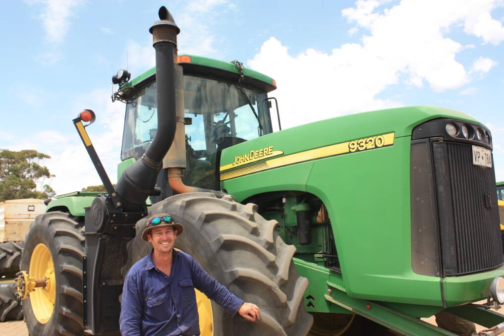 Anthony Haddrill, Northam, next to a John Deere 9320 4WD tractor which later sold for $60,000. Even with 8070 hours on the clock, it represented good value, boasting a John Deere 12.5 litre six cylinder engine delivering 280 kiloWatts (375 horsepower).