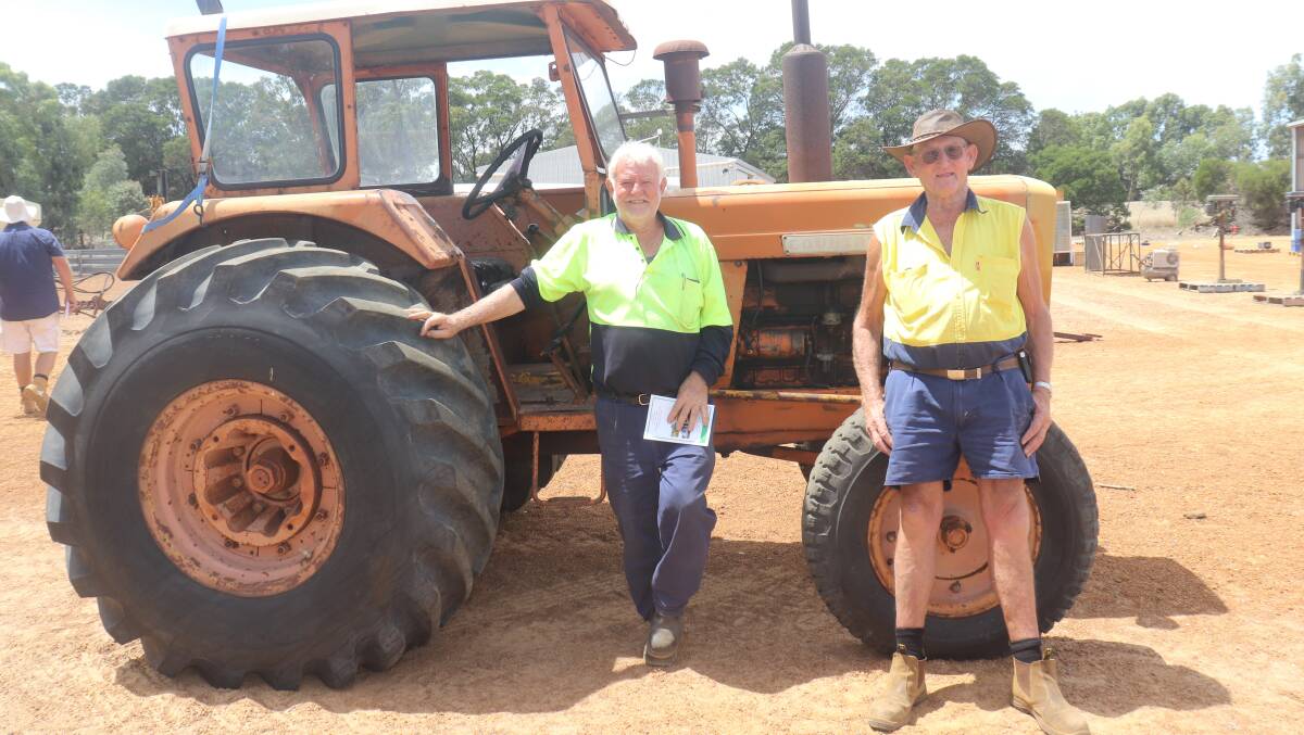 John Backman (left), Esperance and Malcom Ferme, Esperance, looking at the Chamberlain 354 tractor which ended up selling for $7000.