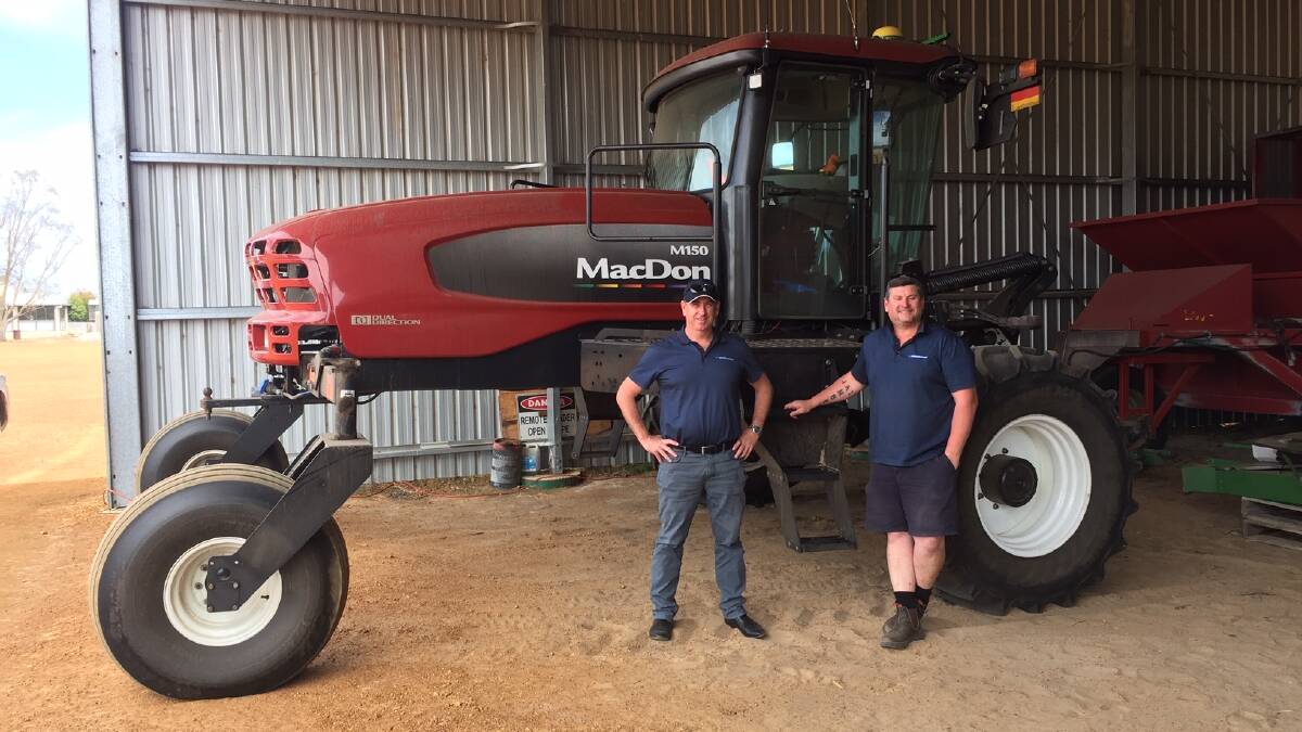 Dealer principal, McIntosh & Son southern branches, Devon Gilmour (left) and senior sales representative Dan Tracey, pictured in front of a MacDon M150 swather this week. There's a reason for the pose.