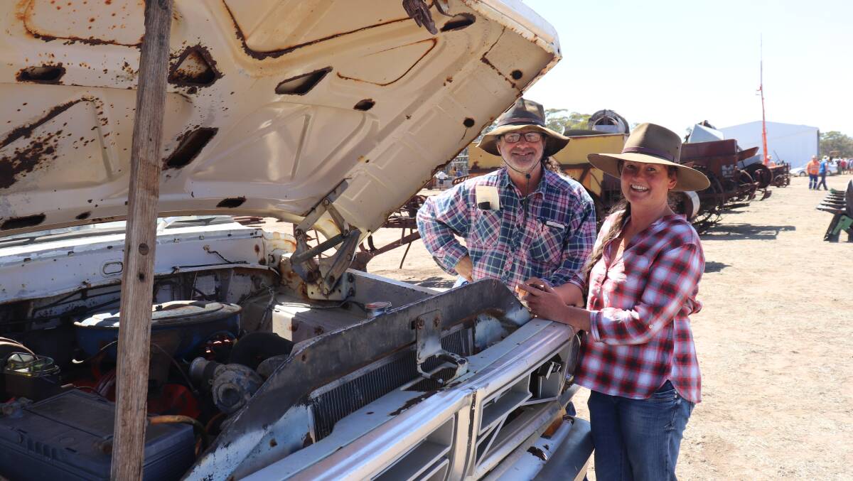 Danny Finlay and Erica Lewis, both from Tenterden, checking out the V8 motor in an old Ford F250 truck that sold for $1000.
