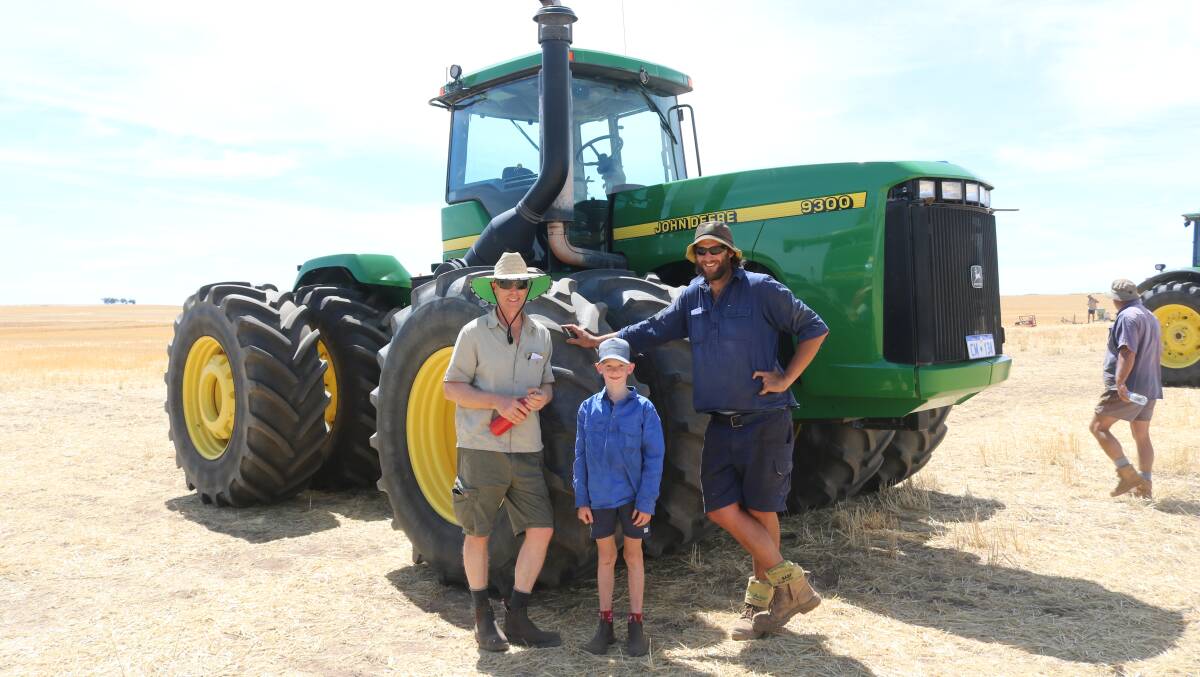 Marcus Gifford, Boyup Brook and son Flynn, caught up with Paul Chatfield, York, while looking over the 1998 John Deere 9300 tractor, which sold for $91,000.