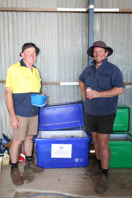 Mingenew Gringos Michael Beare (left) and Geoff Cosgrove sold beers after the clearing sale to raise money for their group.