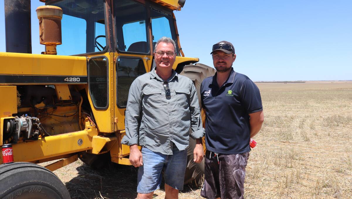 Father and son, Jamie (left) and Jarrod Hood, Ballidu, checked out the Chamberlain tractors on offer. The earlier 4280 model behind them with 7824 engine hours sold for $14,000 while a later 4280B model with 7419 engine hours sold for $13,000