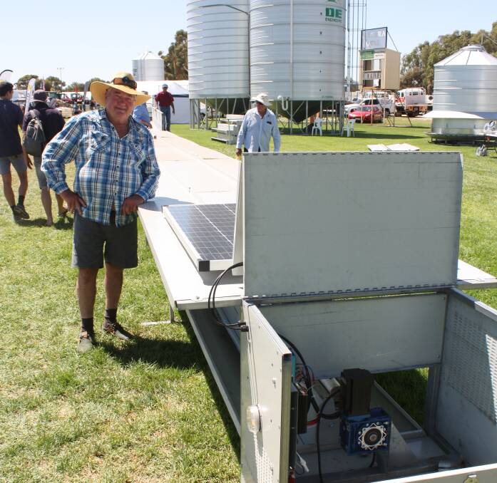 Cuballing farmer Avon Furphy looks over the new DE Engineers automatic sheep feeder at this year's Make Smoking History Wagin Woolorama before it was sold to Ongerup farmer Rivers Hyde.