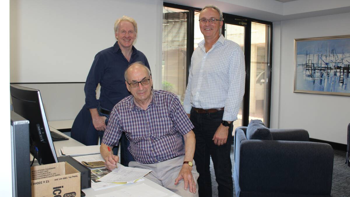 Australia's oldest wool valuer Bill Servent (seated), who turned 80 on March 31, with PJ Morris Exports colleagues, managing director Pete Morris (left) and wool buyer Darren Calder.