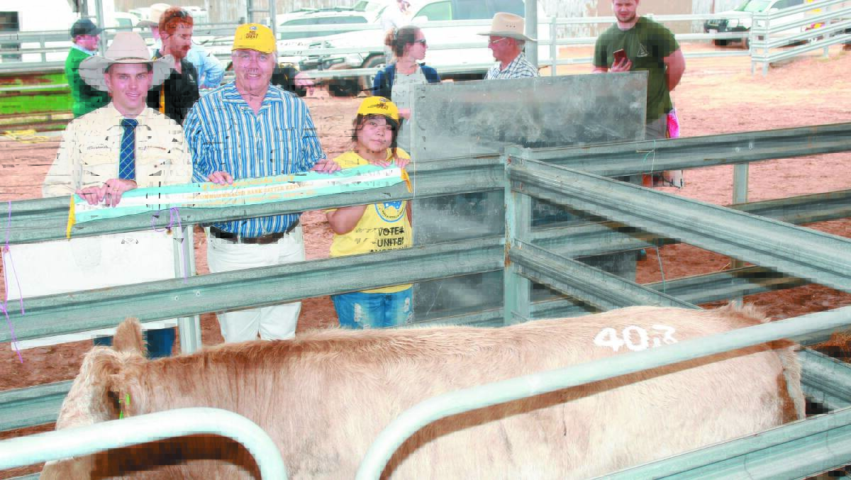  S & C Livestock auctioneer Cameron Petricevich (left), with buyer Anthony Fels, Kojonup and Coco Chien and the $2400 top price steer sold at the prime beef and heifer sale at last week's Make Smoking History Wagin Woolorama.
