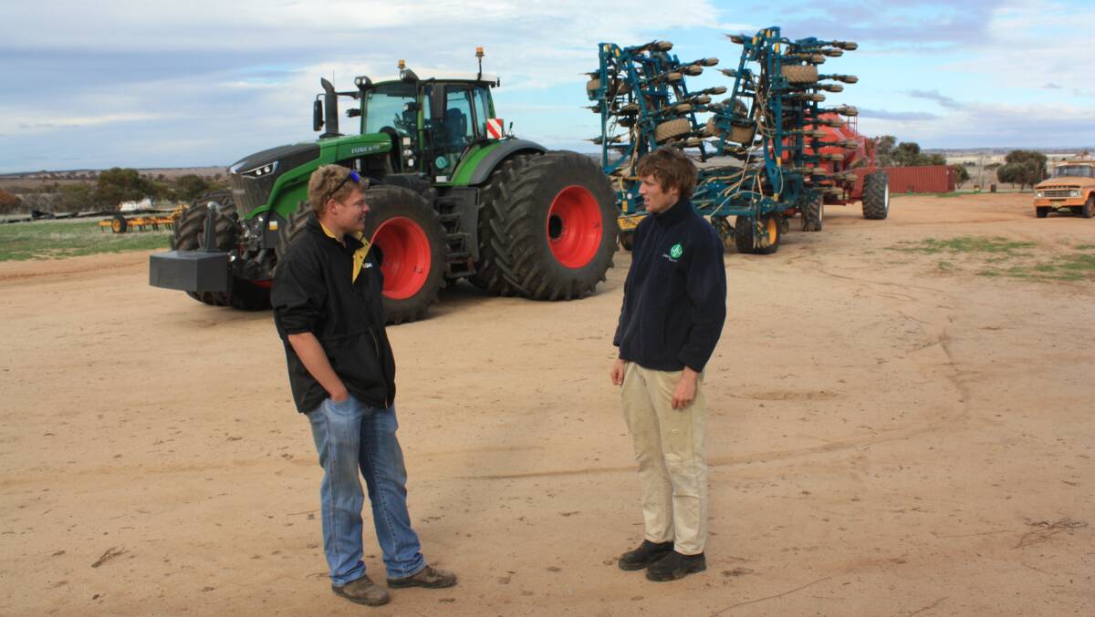  AgWest Machinery Corrigin salesman Connor Baker (left) and Kulin farmer John Wilson discuss the performance of the new Fendt 1050 pulling a 18 metre Equalizer and a Morris 16,000 litre air seeder.
