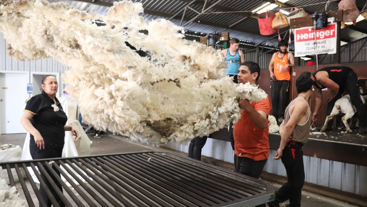 Australian Wool Innovation (AWI) wool handling trainer Nola Edmonds from MJ Shearing, Katanning, watches as Brady Walsh, 16, Bassendean, tosses a fleece on the table at Rylington Park near Boyup Brook during a shearing and wool handling school last year. Eight more schools will be conducted in the Rylington Park shearing shed this financial year, funded entirely by AWI.