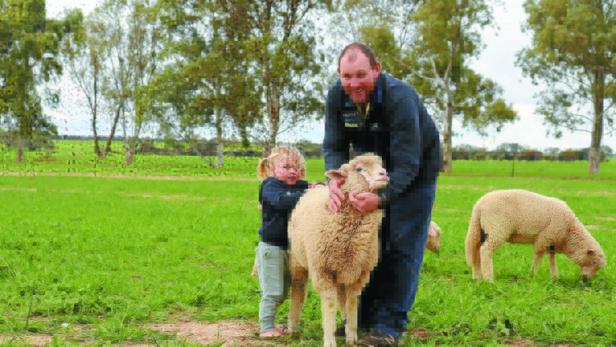 Michael Wanless and youngest daughter Sienna with one of their pet lambs.