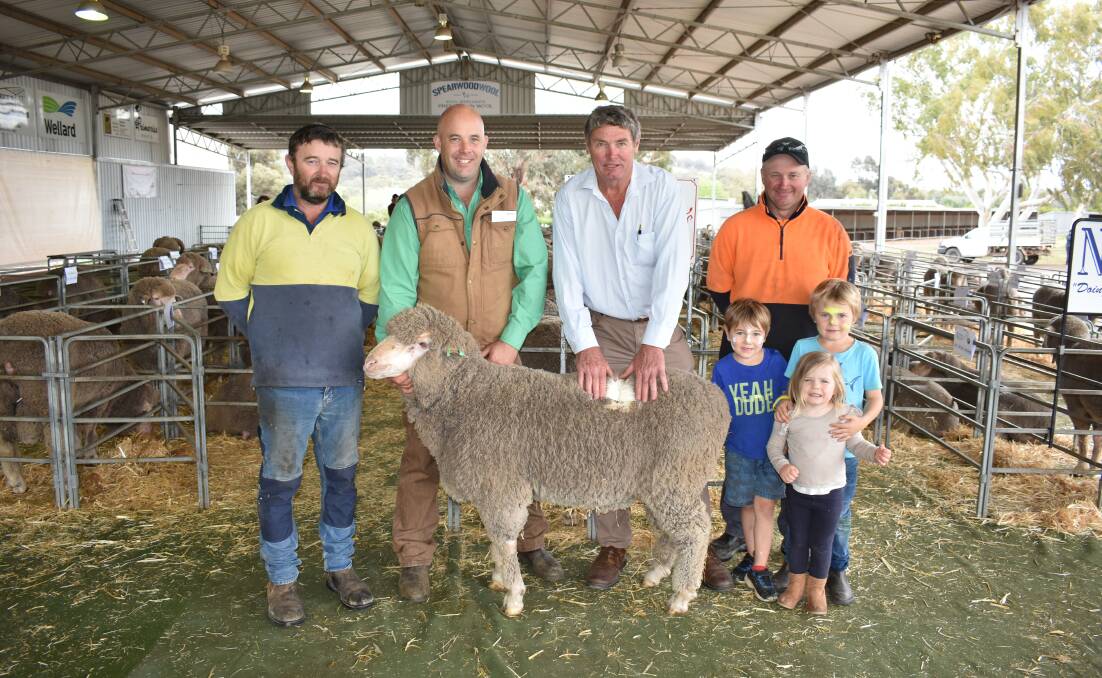 Colin Gillett (left), Williams, Nutrien Livestock Williams agent Ben Kealy, Barooga stud principal Andrew Higham, with grandchildren Archie Higham, 4, Jack Higham, 6, and Charlotte Higham, 2, and Michael Gillett, Williams, with the $1900 top-priced Barooga Poll Merino, purchased by brothers Colin and Michael.