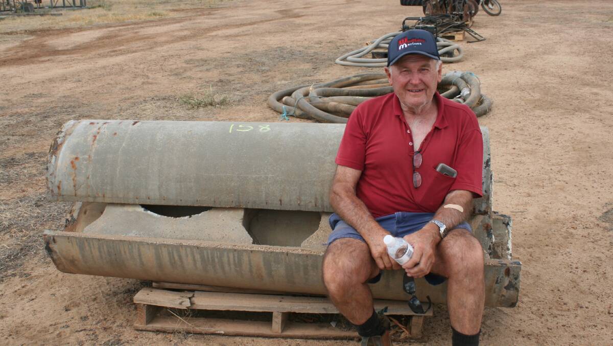Southern Cross farmer Robert Dal Busco was taking a rest from the heat, sitting on some old cement troughs which sold for $5.