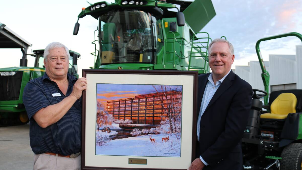 Company operations director Gollie Coetzee (left), Perth, accepted this gift of a painting of John Deere's snow covered head office at Moline, Illinois, in the United States, to mark the occasion of the opening of the company's South Guildford premises from Deere & Company senior vice-president marketing agricultural and turf regions 3 & 4 Americas, John Lagemann, Moline.