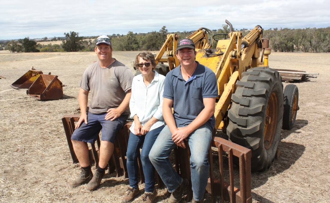 Vendor Jo Webb (centre), Kojonup, is flanked by her son-in-law Simon Zacher (left) and son Anthony sitting on 'old faithful' before the start of last week's clearing sale. The Chamberlain rear-end loader has chalked up thousands of hours as the farm's dog's body and was the first machine when Jo and her husband Don started farming the Kojonup property, which will be leased. Don died 18 months ago and while farming will now take a back seat for Jo, she will continue to live on the property. Incidentally, old faithful sold for $2900.