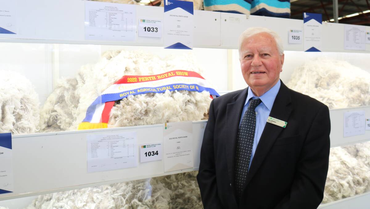 RASWA steward in charge of wool Ken Walker, Perth, with WA College of Agriculture, Cunderdins, champion farmers ram fleece.