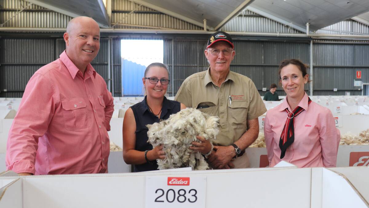 Murray Hall (second right), West Kendenup, was one of the few woolgrowers able to watch his clip sell at the Western Wool Centre before COVID-19 visitor restrictions were introduced. He brought farm hand and stock person Meagan Parsons (holding wool) with him. Also pictured are Elders' Great Southern district wool manager Travis King and wool sales manager south Alice Wilsdon.