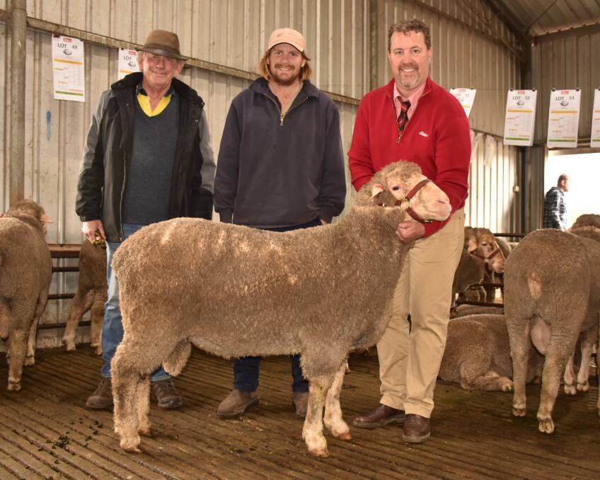  Far Valley Dohne stud principal David Kain (left), with buyer Mitch Applegate, Mollerin Rock Dohnes, Cadoux and Elders stud stock auctioneer Nathan King holding the $6100 top-priced ram at last Fridays Far Valley on-property ram sale at Arthur River.