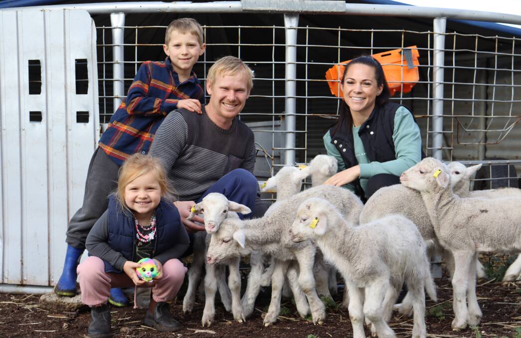 Fourth-generation Merino sheep farmer Wade Brown with daughter Evie, 3, son Mason, 8 and wife Jess.