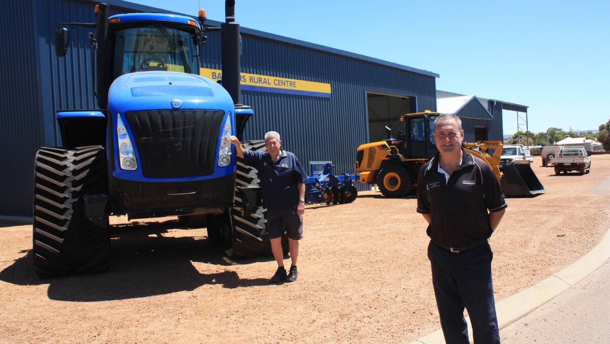 Baxters Rural Centre dealer principal Russell Baxter (front) carries the business into the fourth generation watched by a proud father Ken Baxter, who officially retired as dealer principal in 2002. The pair, with their respective wives Corrina and Beryl, will next Friday welcome guests to the 100th anniversary celebrations at the dealership. 