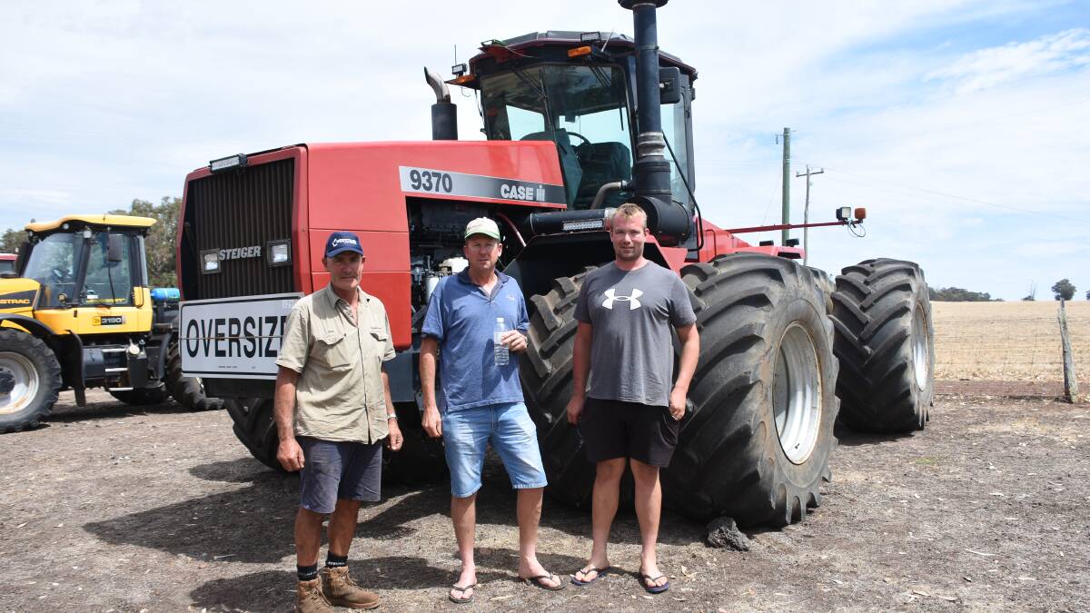 Looking over the 9370 Case IH articulated tractor before the sale were vendor Gray Cavanagh (left) with Glen Wilkinson and Michael Huendlings, Badgingarra. It later sold for $35,000.