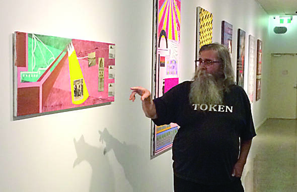  Artist Brian McKinnon in front of his artworks featured at the Geraldton exhibition.