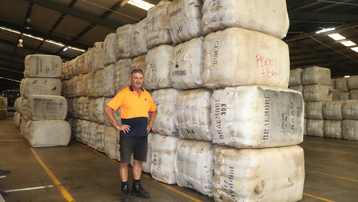 Frank Urbano, manager of sea container packing company IWD Pty Ltd, beside a wool order waiting to be packed into containers and shipped to China.