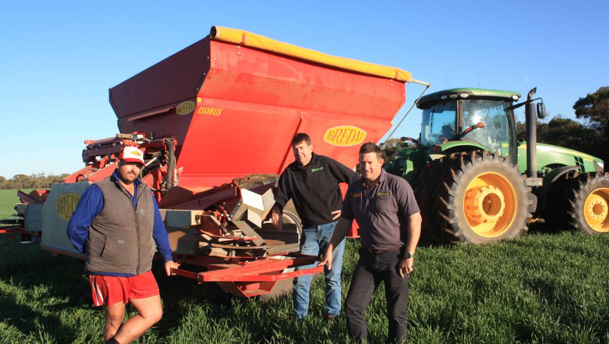 Irwin farm employee Nick Shehan (left), Willow Green, with Burando Hill salesman Michael Kowald, Katanning and Geraldton branch manager Jonathan Moss, in front of a Bredal 105XE spreader.