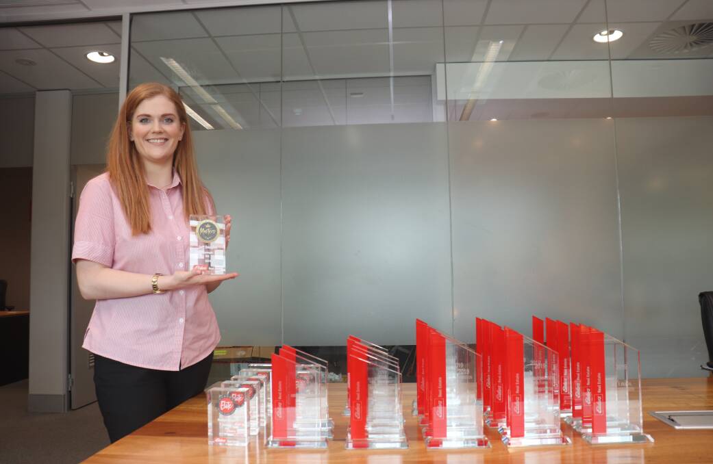 Karina Brown, Elders senior real estate administration, with the host of trophies that would normally have been presented to the award winning real estate sales representatives and branches at a gala function.