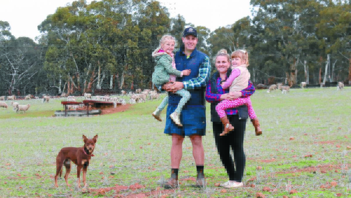 Nic and Shona Smith with daughters Olivia and Sienna. Merinos have been part of their Wannamal property since 1945.