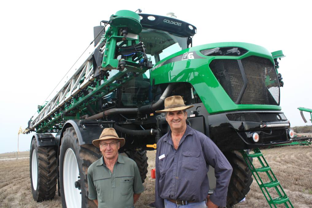 Mt Barker farmer David Slade (right) with his friend visiting from England, Dennis King, in front of a Goldacres G6 self-propelled boomsprayer, which Mr Slade later bought for the sale top price of $400,000.