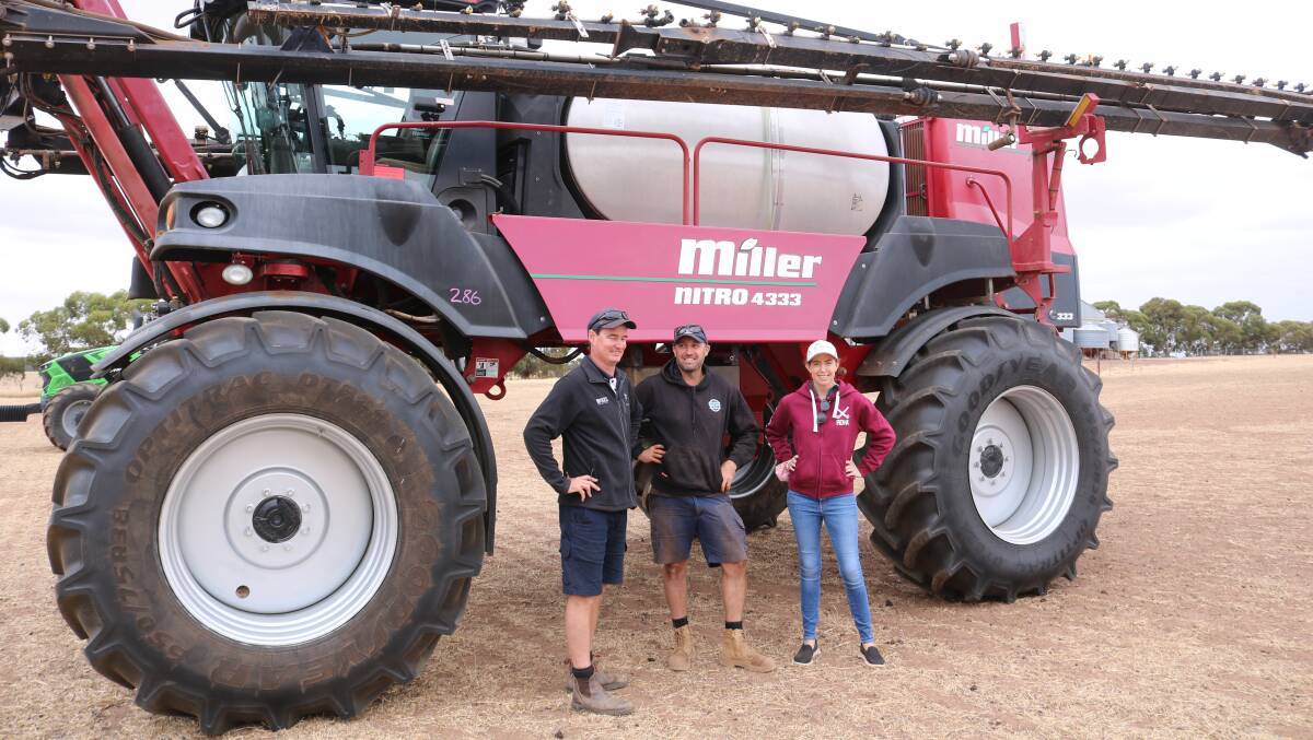 Kim Gooding, Kukerin Rural Services, with Chad and Jess Davidson, Kukerin, inspected the Miller Nitro self propelled boomsprayer which topped the sale at $172,000.