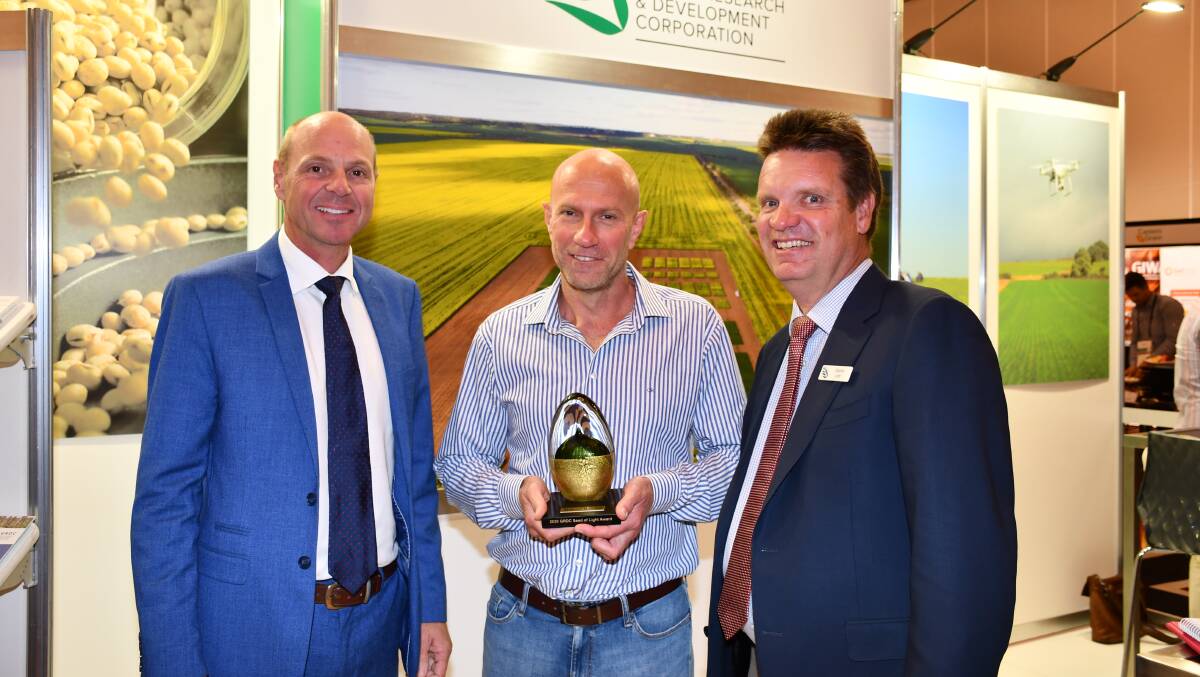 GRDC chairman John Woods (left), Seed of Light winner Wayne Pluske and GRDC western panel chairman Darrin Lee at the Grains Research Update, Perth, on Monday morning.