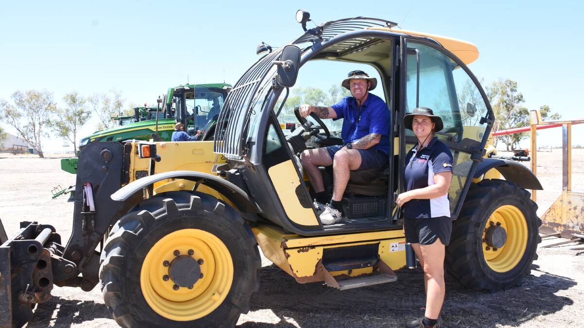 Looking over the 2011 New Holland LM740 telehandler before the sale were Darren and Hayley Sewell, Goomalling. The Sewells later bought the telehandler for $66,000 in the sale.