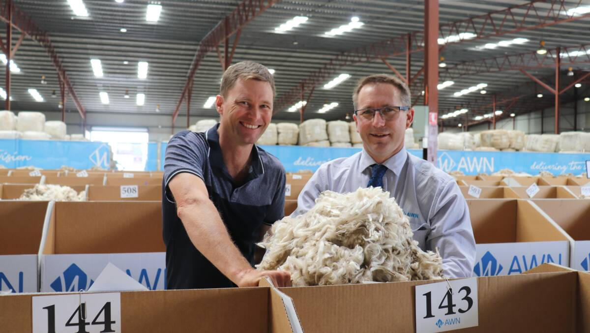 Peter Wilkinson (left), Dandaragan and Australian Wool Network wool manager Greg Tilbrook with a sample of Challara wool which was in demand at the Western Wool Centre.