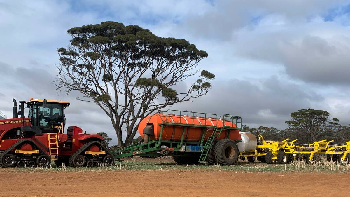  The full seeding outfit being used to sow this season's canola program on the Smith family farm at Dongolocking a borrowed tractor, their existing Ausplow Multi-stream air cart and their week-old Seed Storm 18-300 air drill seeder bar.