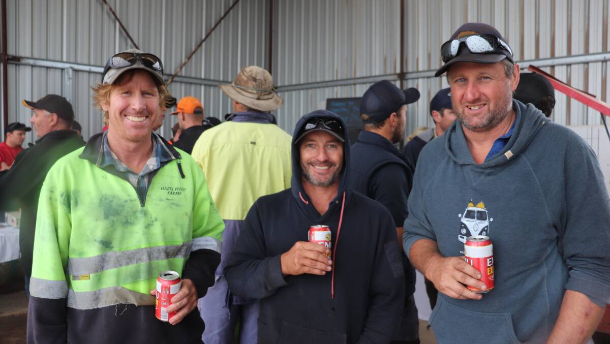 Ongerup farmers Greg O'Neill (left), with cousin Brendon O'Neill and Chris Stone, Monjebup, enjoying a cold drink at the Elders clearing sale at Boxwood Hill. None of them purchased anything but were interested in seeing how the sale went and enjoyed catching up.