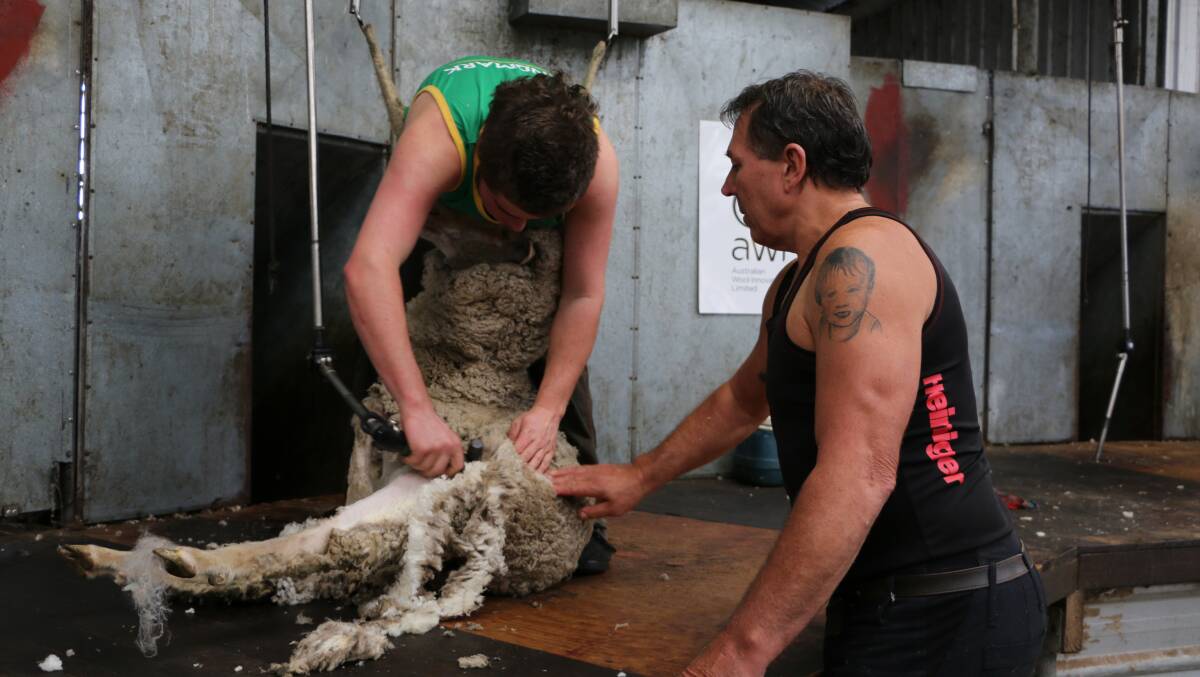 Todd Wegner (right), Heiniger Western Australia territory sales manager, gives some pointers to shearing student Conway Clinch, Esperance.