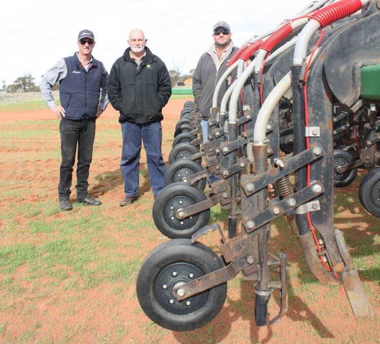 Discussing the Furrow Management Systems liquid delivery system plumbed to a 15.2 metre DBS precision seeder last week, were Wilchem business development manager and technical support Burt Naude (left), Roland Labuschange and his son Rowley. The Labuschange family has been among 30 early adopters of using liquid nutrient mixes and according to Rowley, average yield increases have been 300 kilograms a hectare on acid deep sand soils.