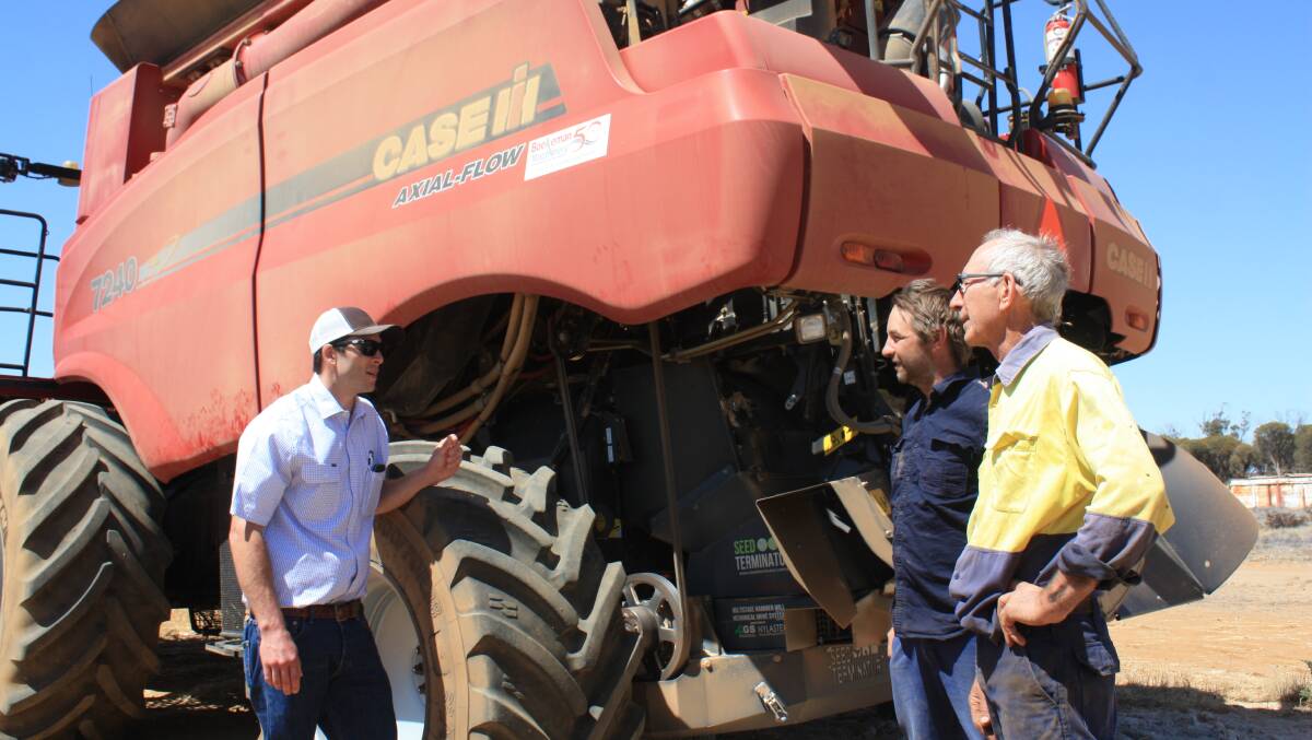 WA Seed Terminator representative Joe Limbaugh (left), chats with east Wubin farmers Boyd and Keith Carter about the performance of the Seed Terminator on this Case IH 7240. The Carters also have another unit installed in their John Deere S680 header.