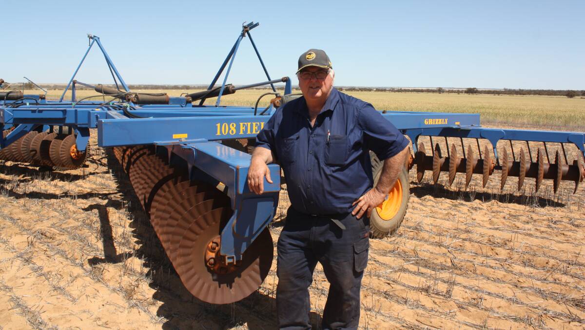 Kalannie farmer Graeme Hathway next to a Grizzly Farm Boss offset disc machine which later sold for $70,000.